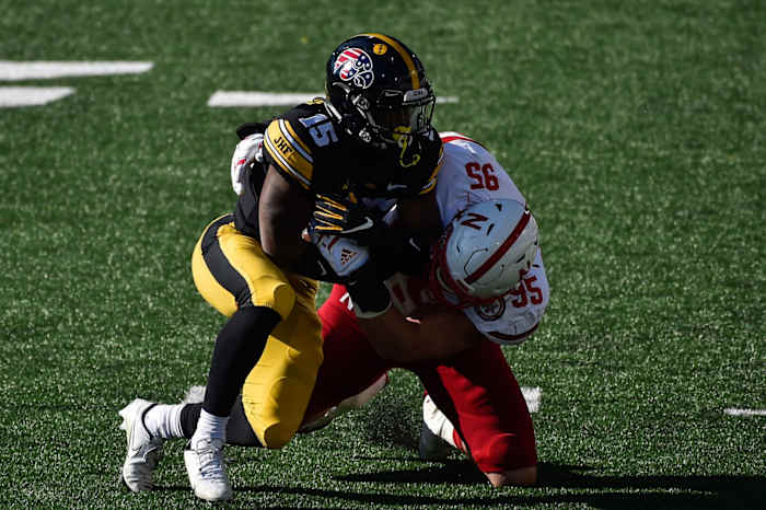 Iowa running back Tyler Goodson (15) is tackled by Nebraska's Ben Stille (95) during the first quarter at Kinnick Stadium. (Jeffrey Becker-USA TODAY Sports)
